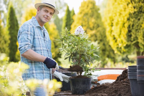 Worker performing a risk assessment on a garden site